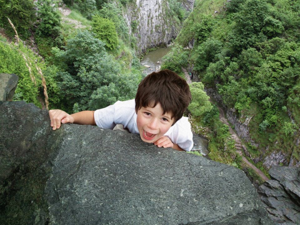 photo manipulated image of child climbing cliff